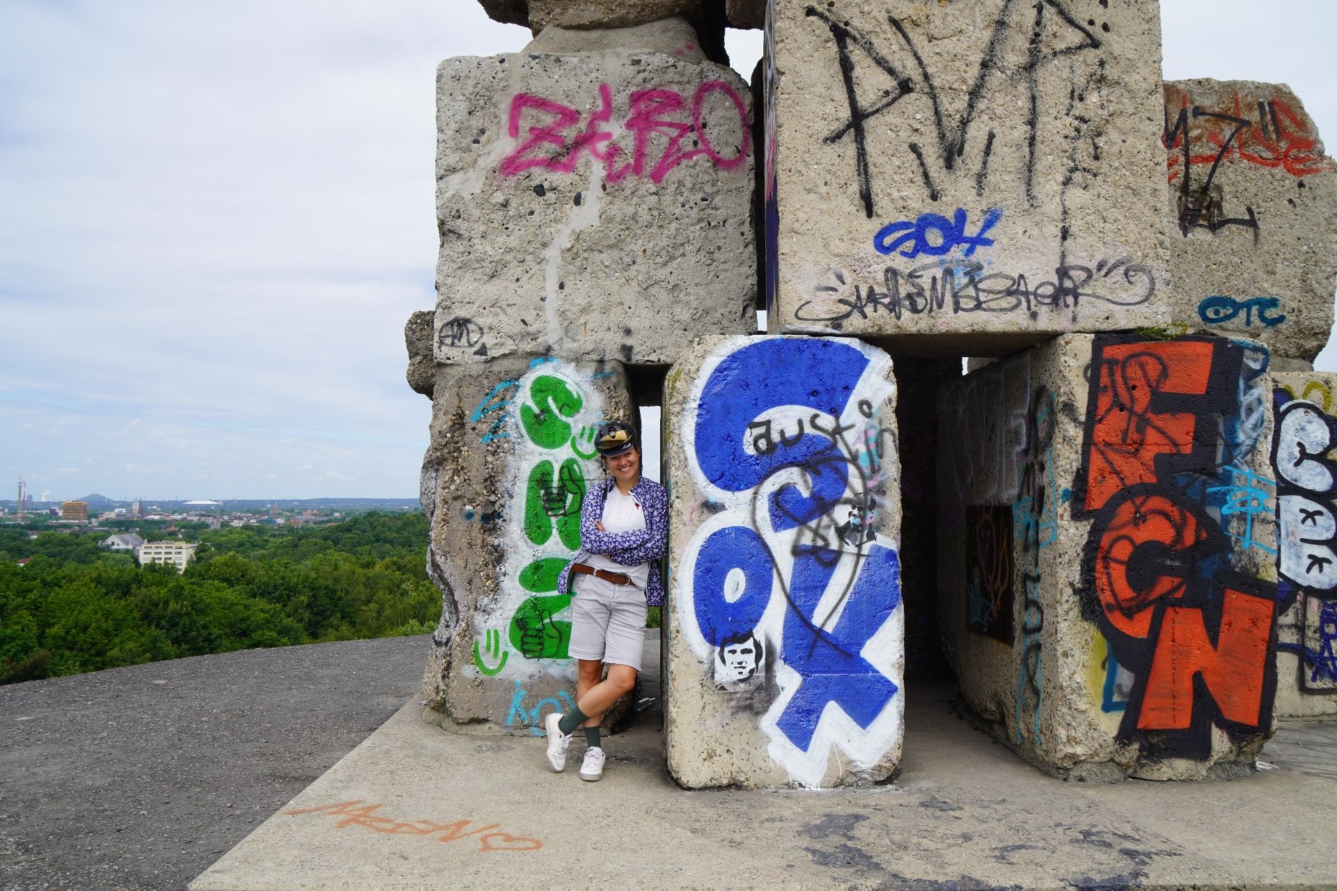 Jule Wagner, A woman stands next to the graffiti-covered Himmelstreppe at the Halde Rheinelbe in Gelsenkirchen
