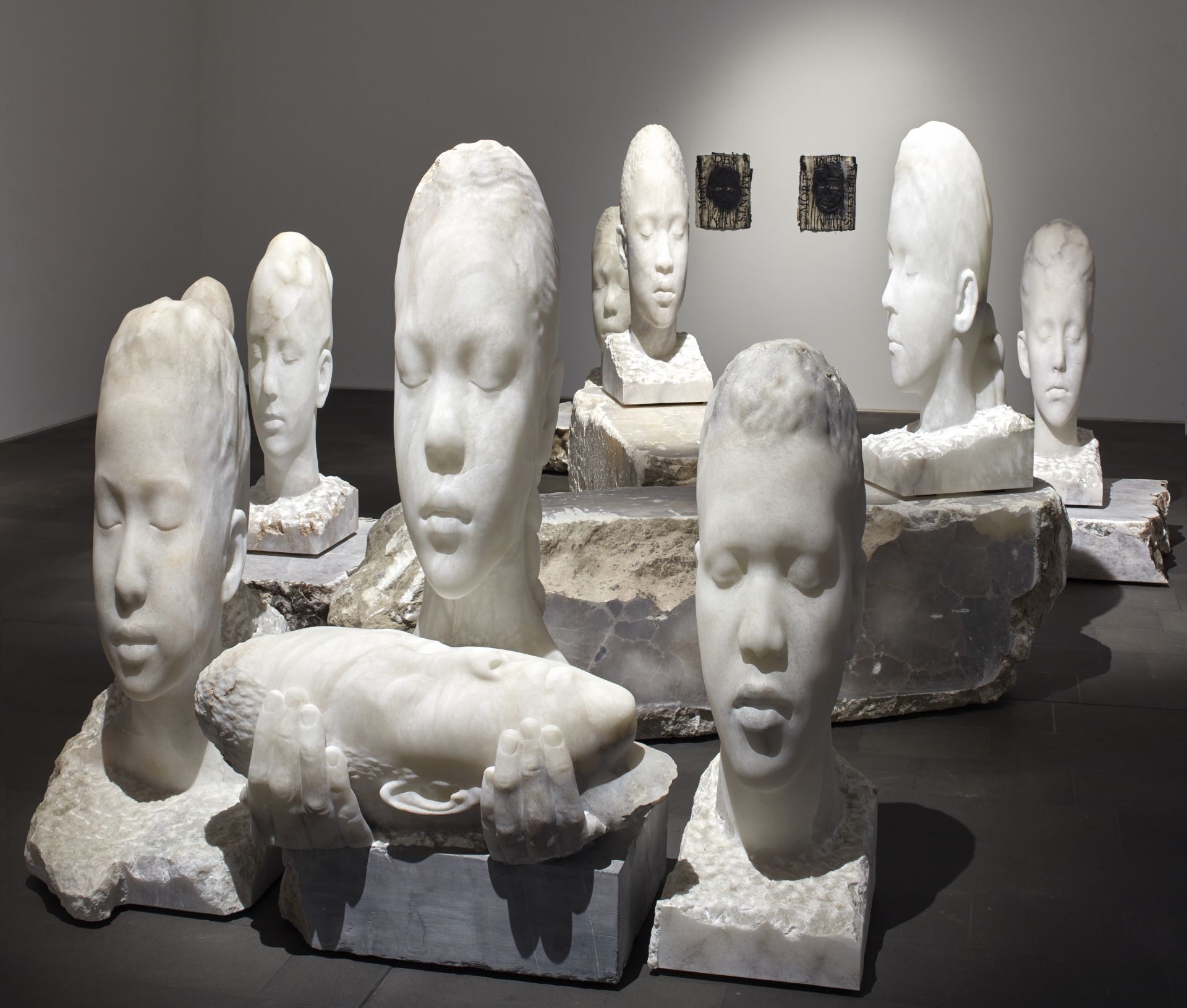 Monumental female heads, in this case carved from marble, embody introspection and symbolize universal human values such as peace, hope, and spirituality