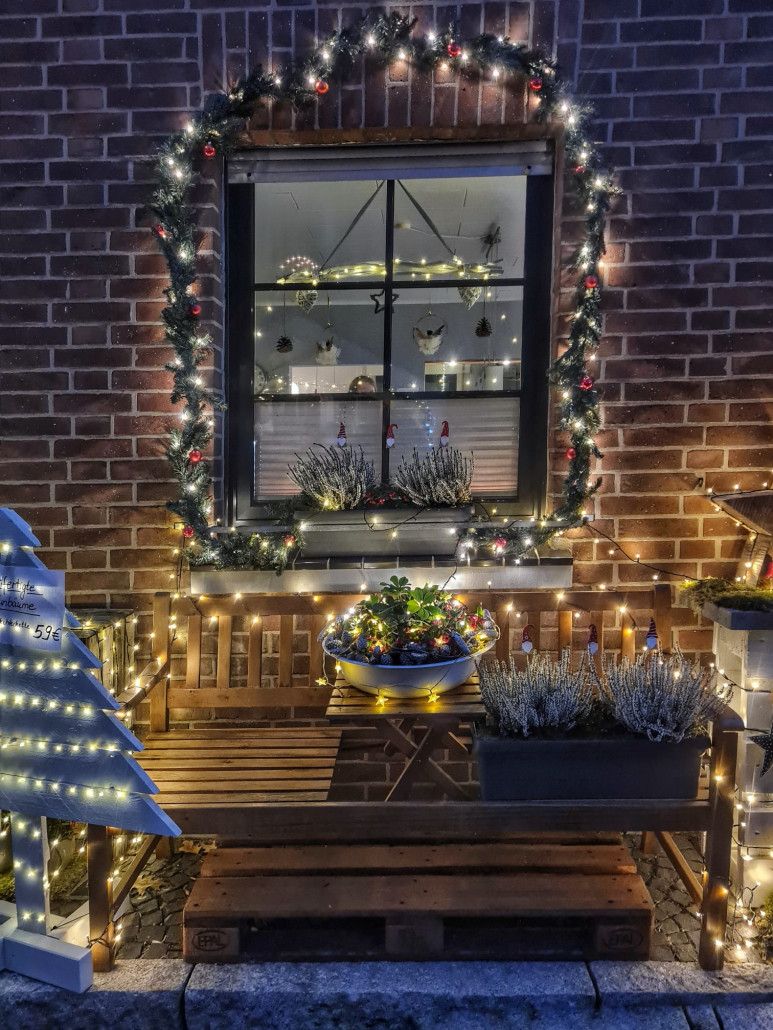 One of many windows decorated for Christmas with fairy lights to look at.