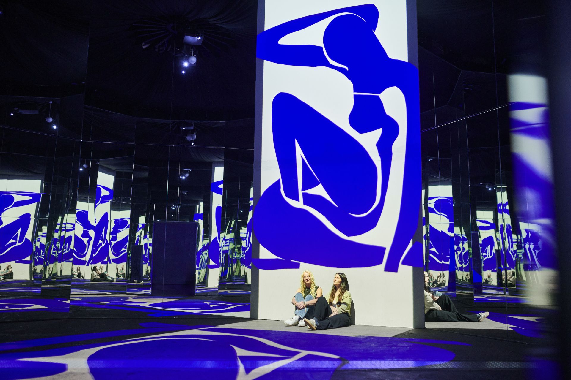 The combination of giant projections and mirrors creates the sensation of walking right through the artworks