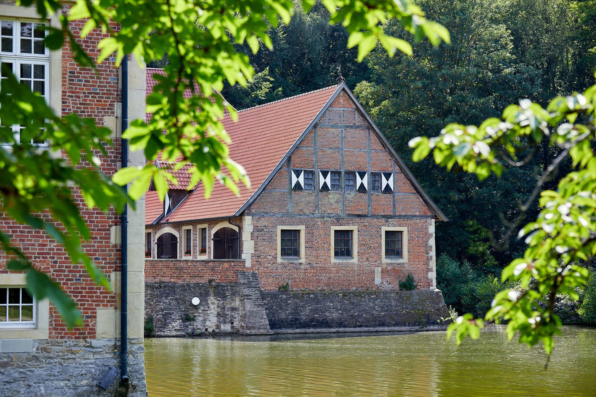 View through the trees to Hülshoff Castle in Münsterland