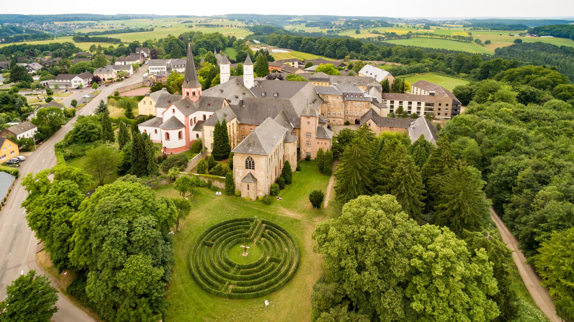 The three characteristic towers of the basilica of Steinfeld Abbey can be seen from afar