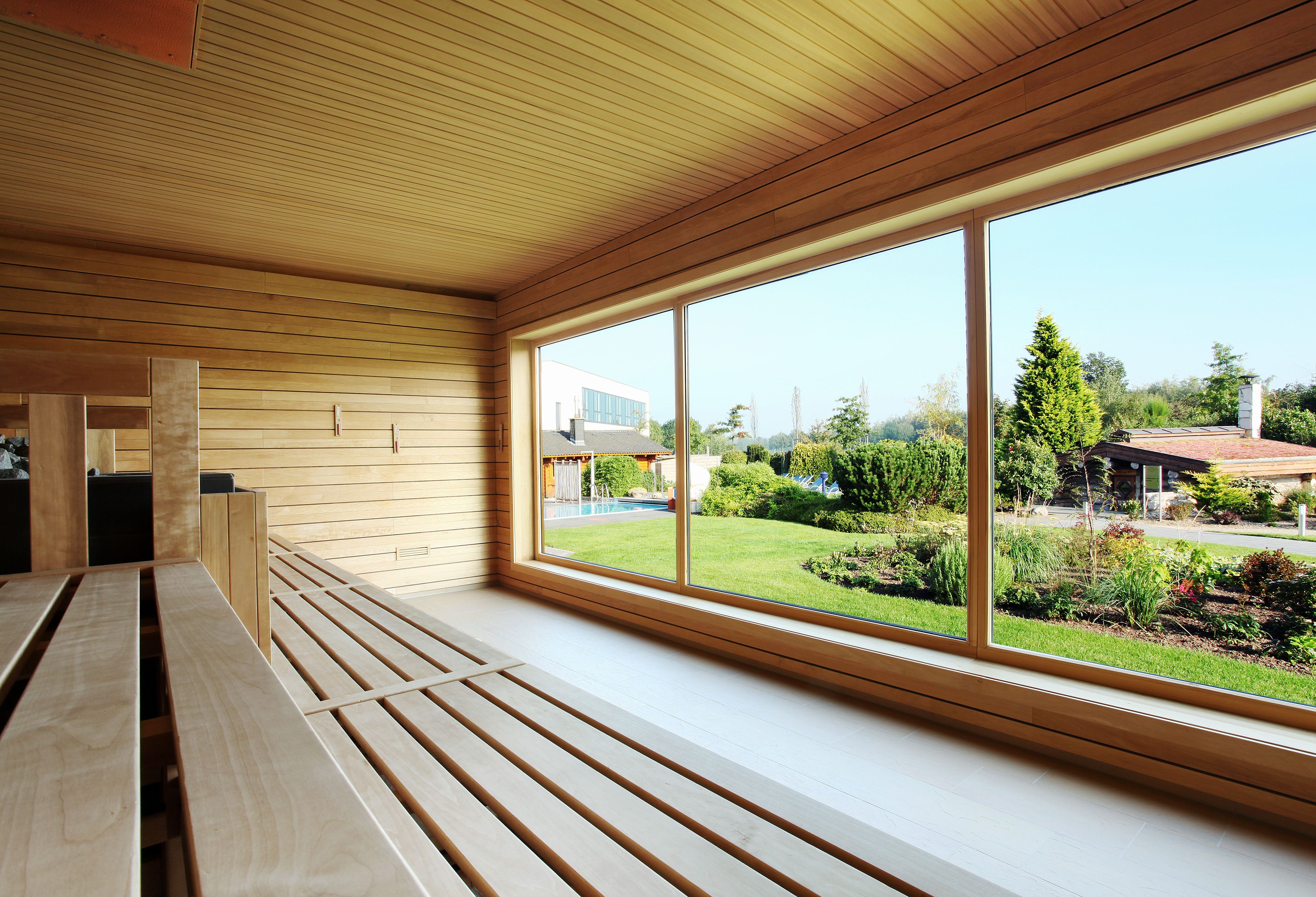 Interior view of the See Park Janssen panorama sauna in Geldern with large windows offering a view of a garden