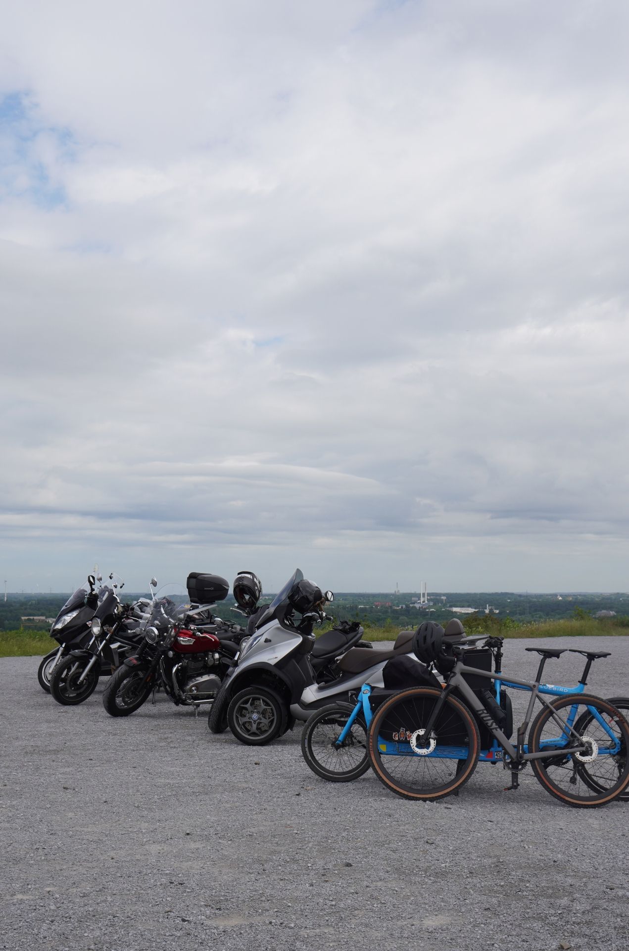 A row of motorbikes and bicycles at the Halde Beckstraße in Bottrop