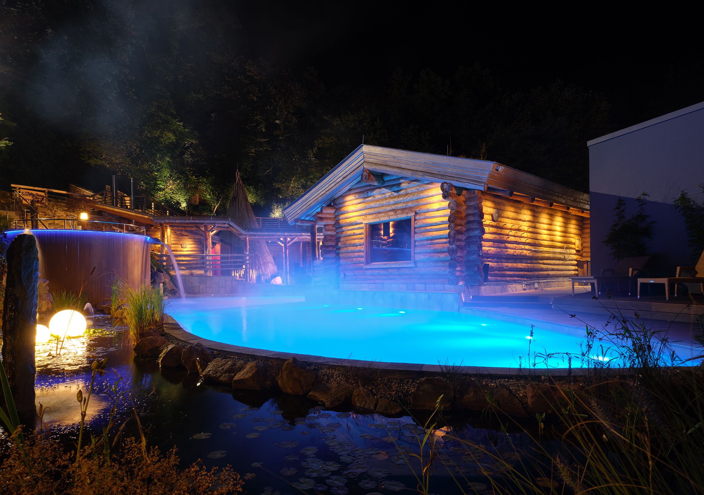 The Carolus Therme at night, illuminated with blue light