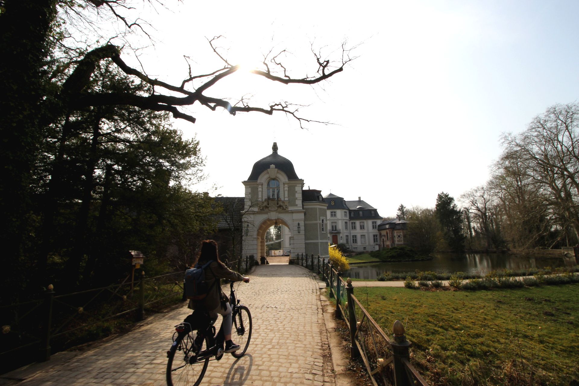 A person rides a bicycle to Türnich Castle