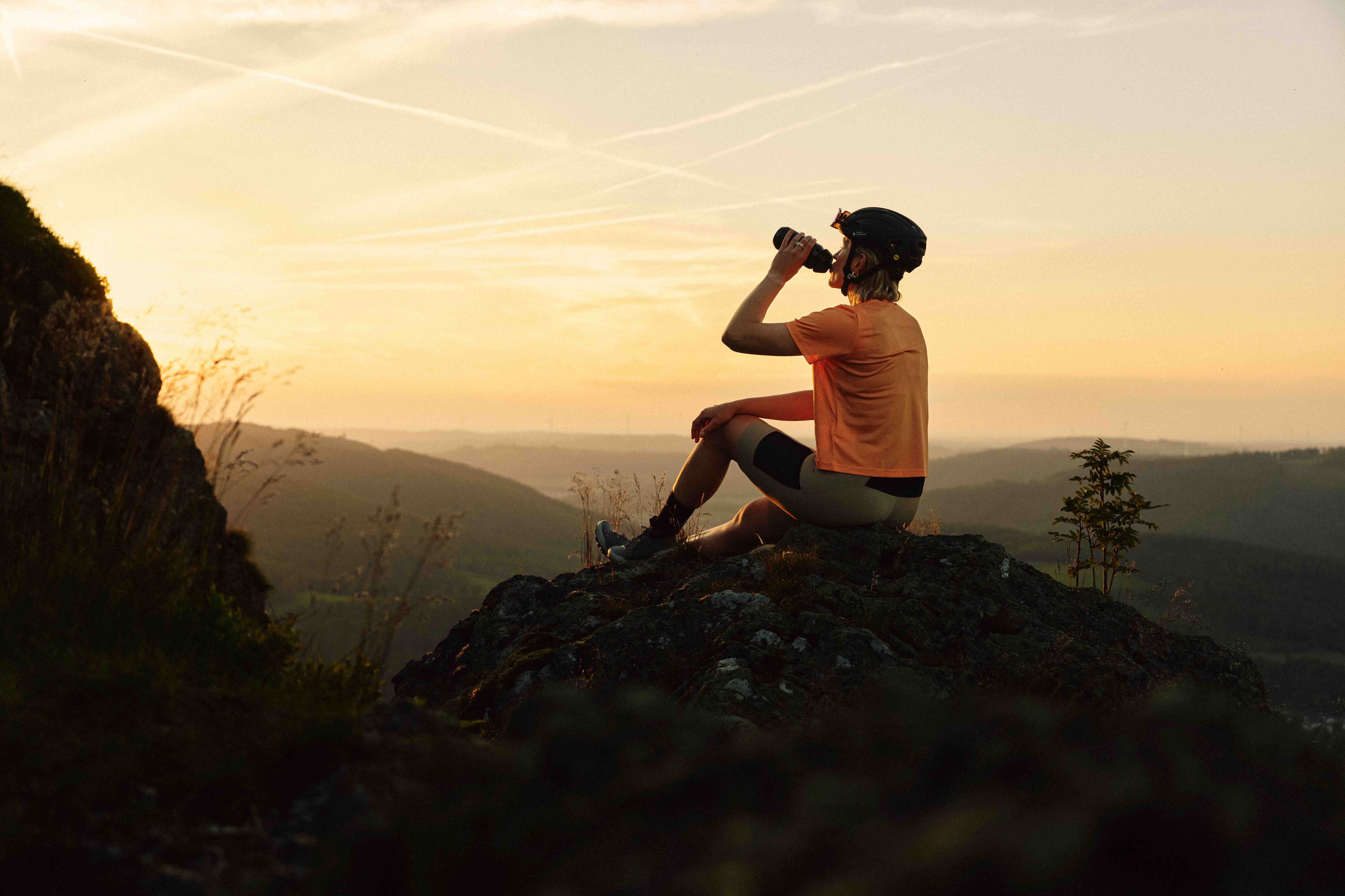 A gravel biker at sunset on one of the Bruchhauser Steine in the Sauerland.