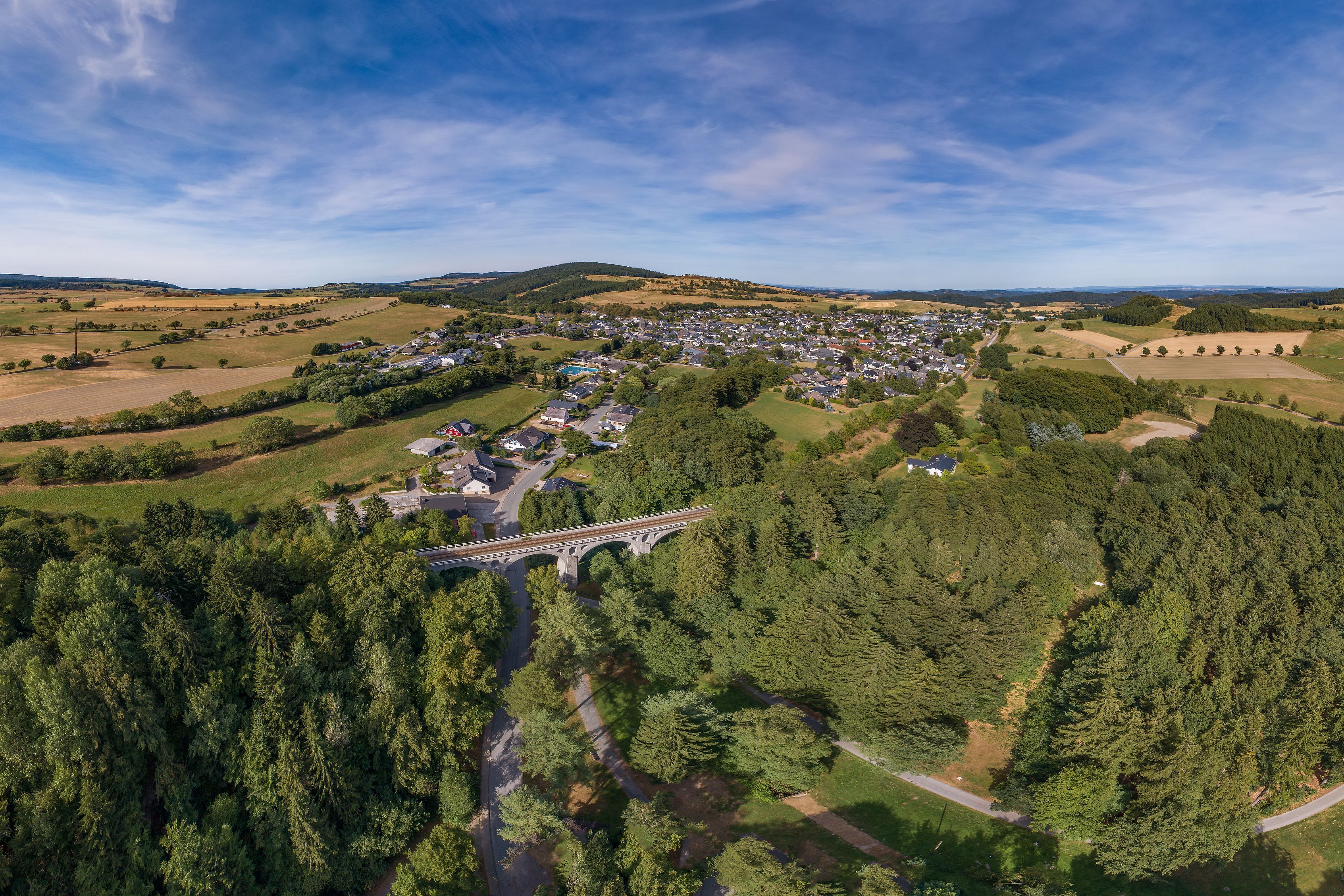 Aerial view of Usseln: A bridge crosses a forest.