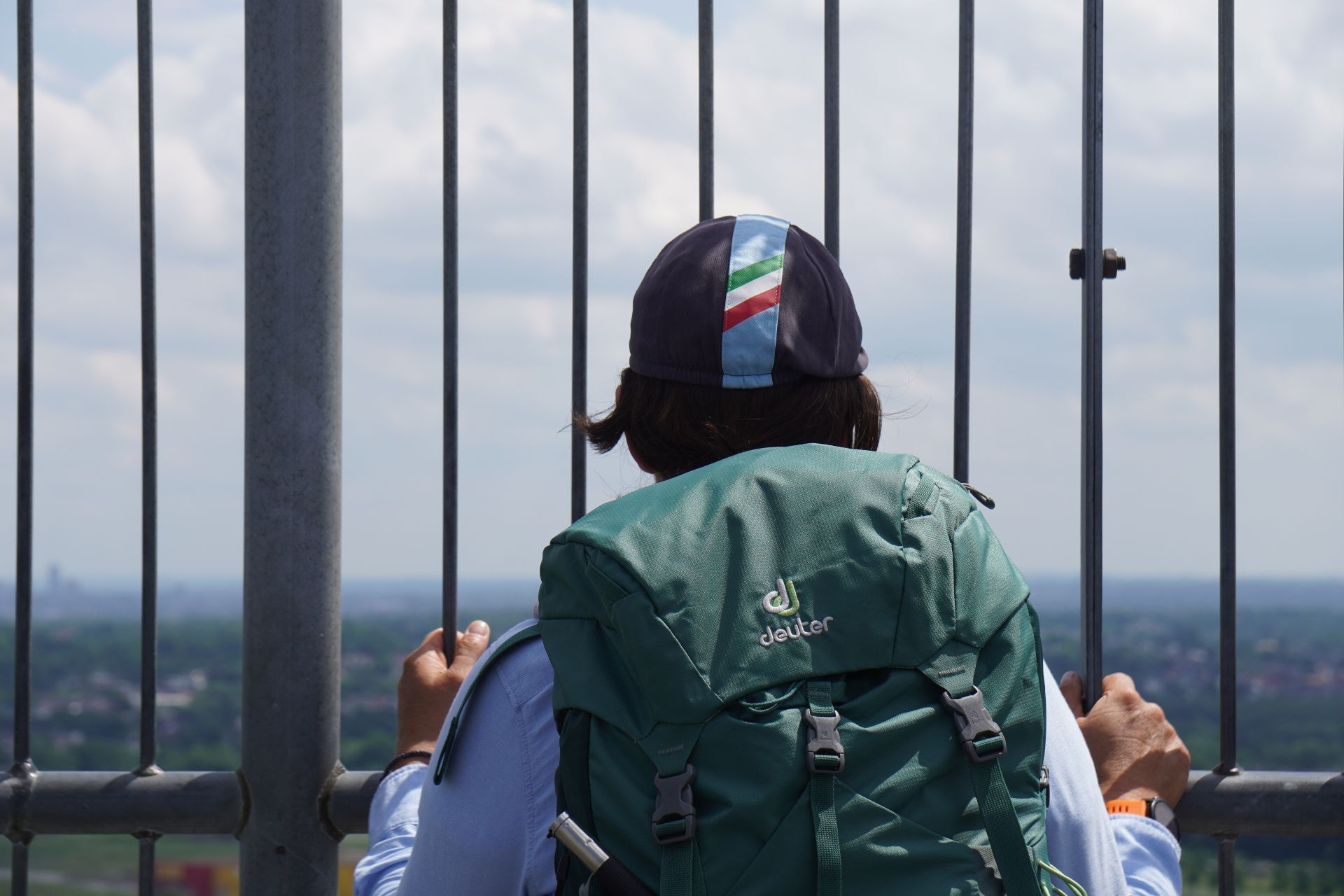 A person with a backpack enjoys the view from the Gasometer