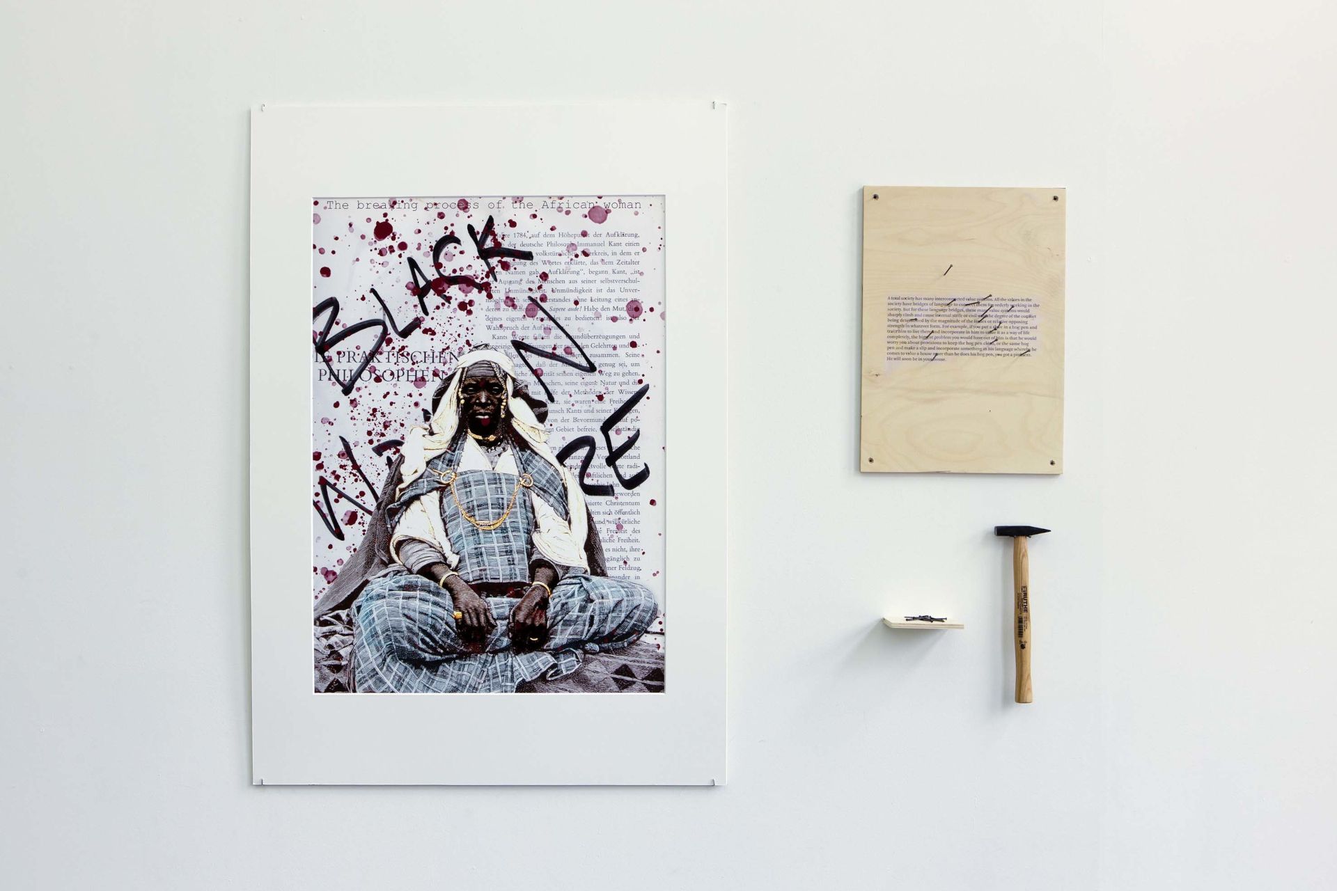 One section of the installation invites the audience to symbolically pierce through racist texts with a hammer and nails