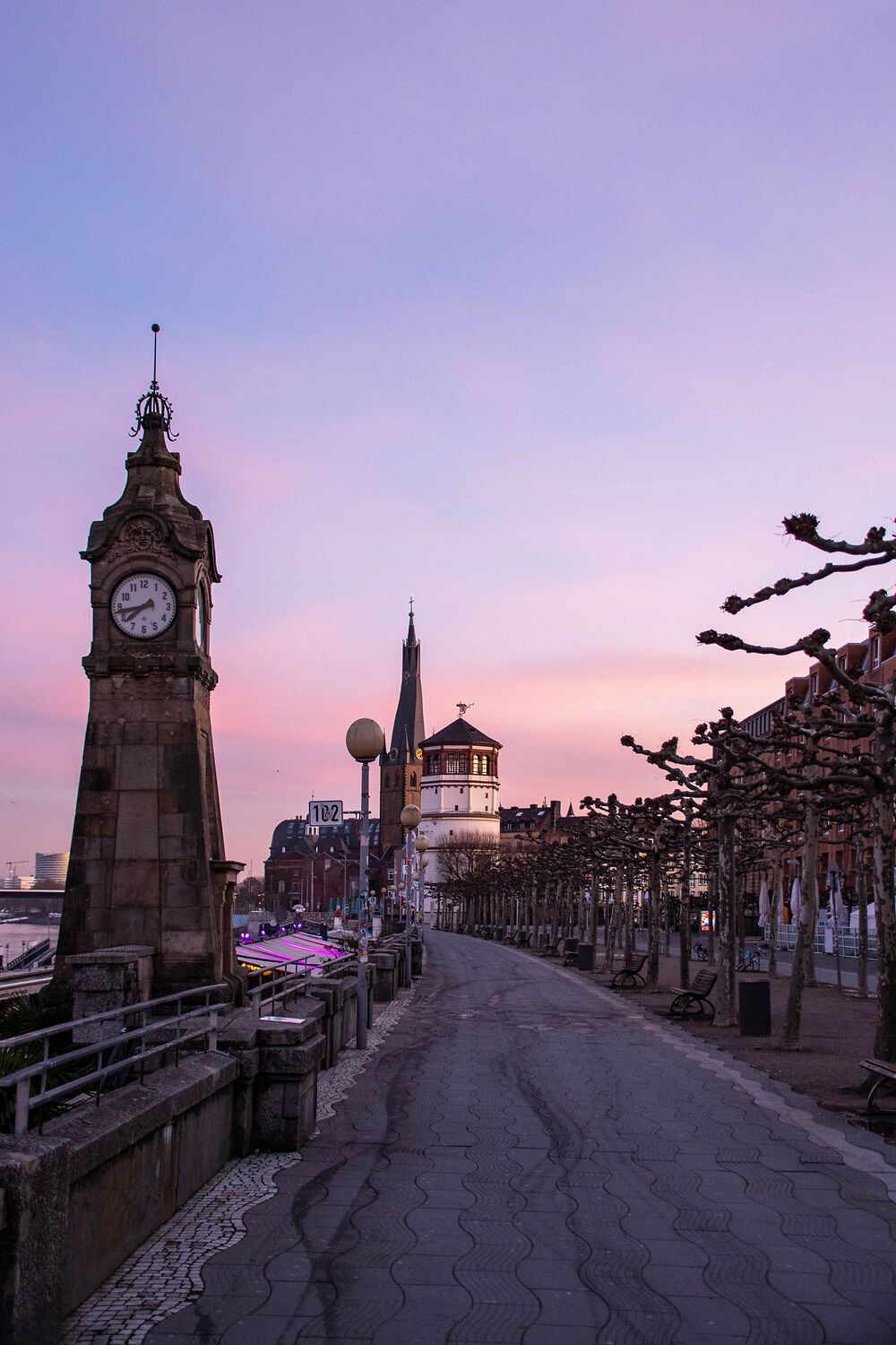 Rhine promenade in Düsseldorf at sunset.