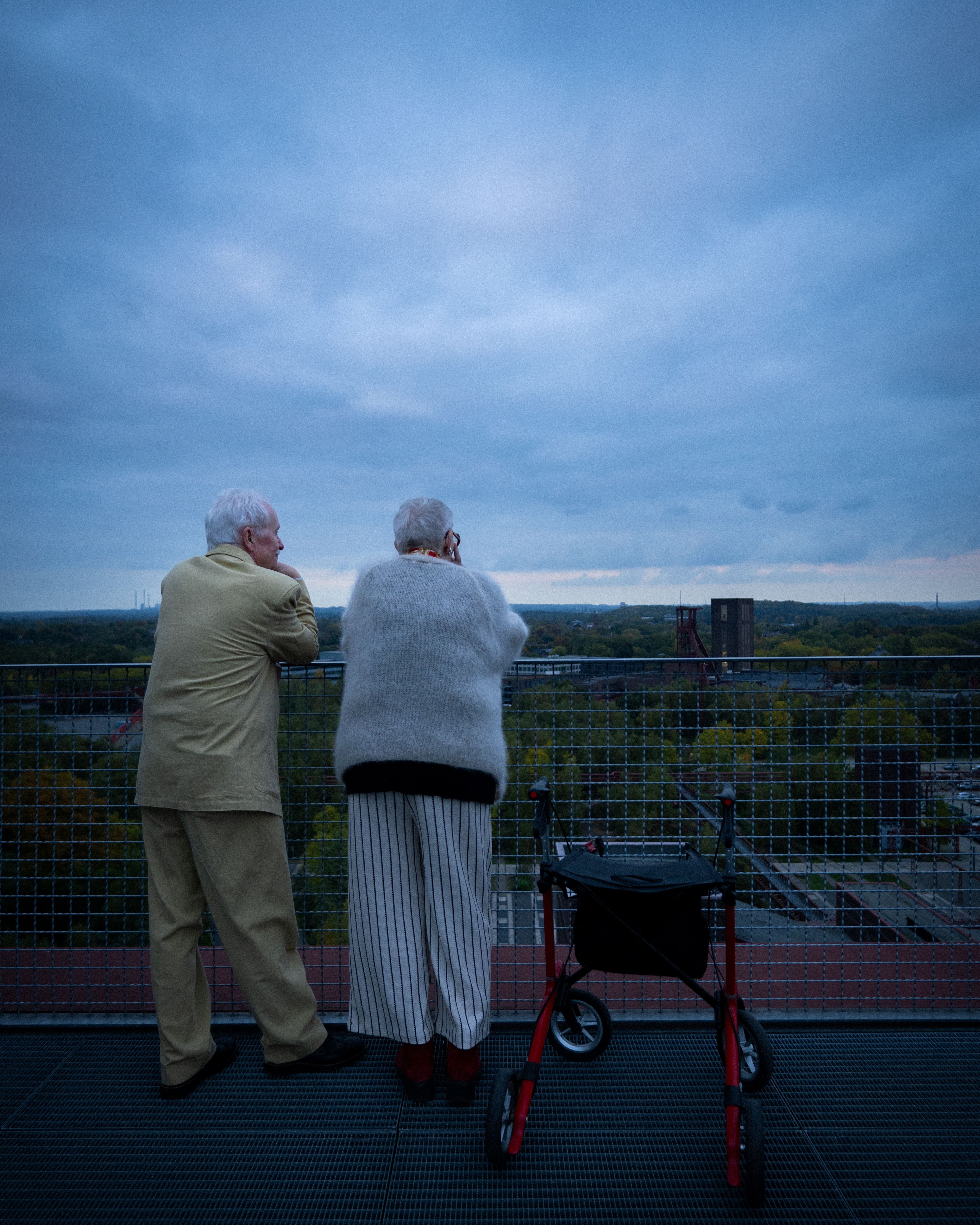 An elderly couple enjoys the view from the winding tower of the Zollverein Coal Mine Industrial Complex