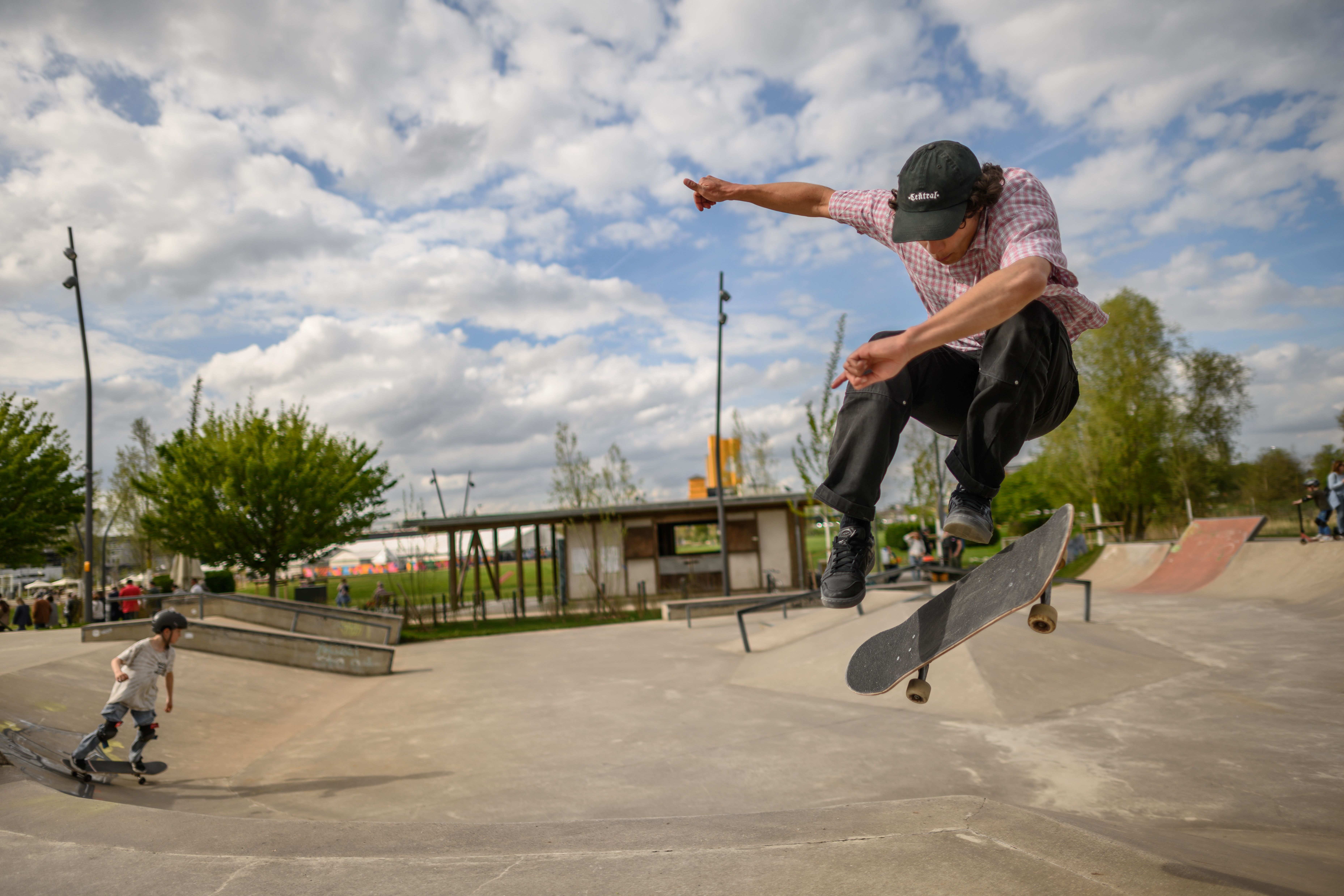 A skateboarder jumps into the air on the grounds of the Neuss 2026 State Garden Show.