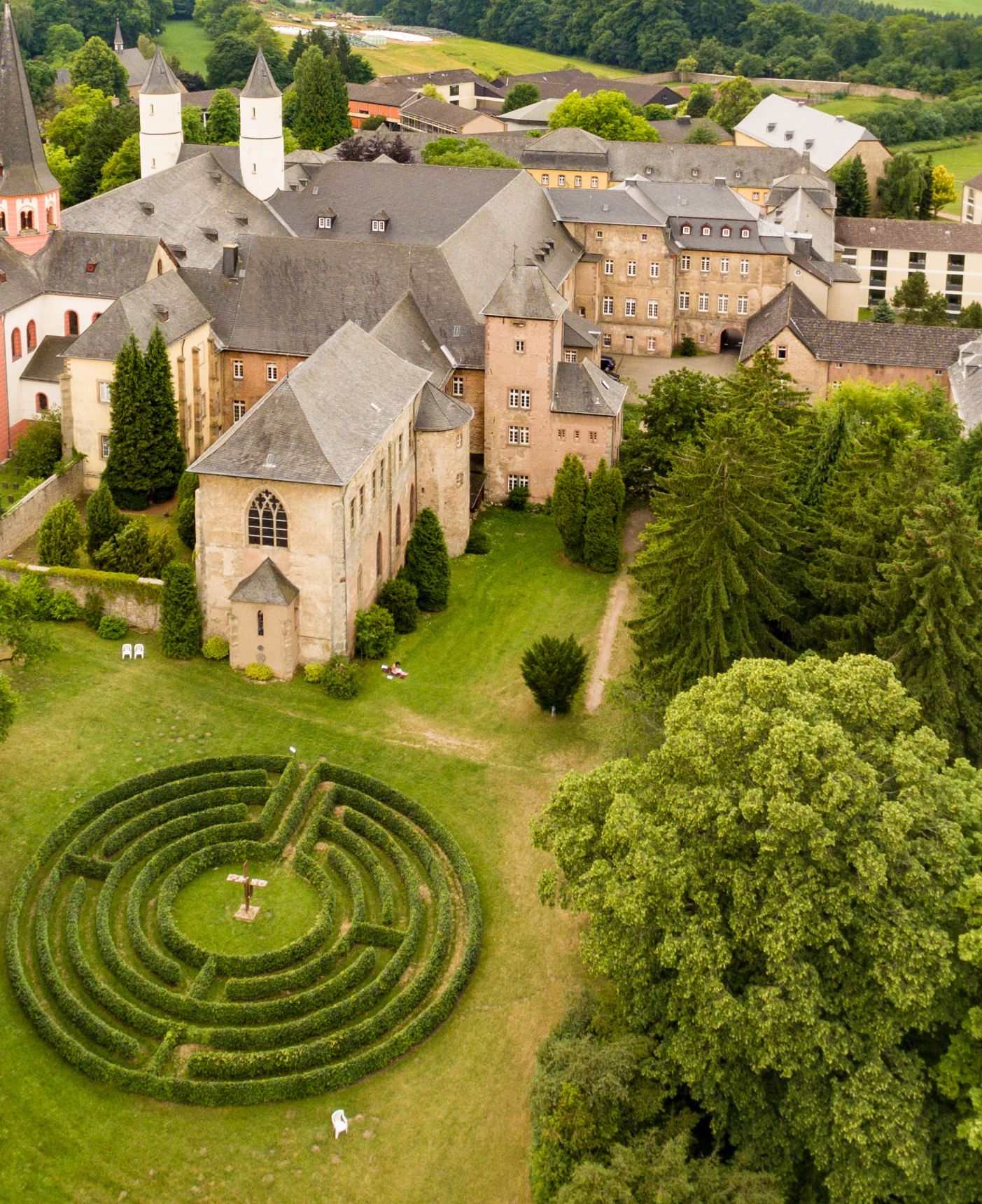The three characteristic towers of the basilica of Steinfeld Abbey can be seen from the entrance gate