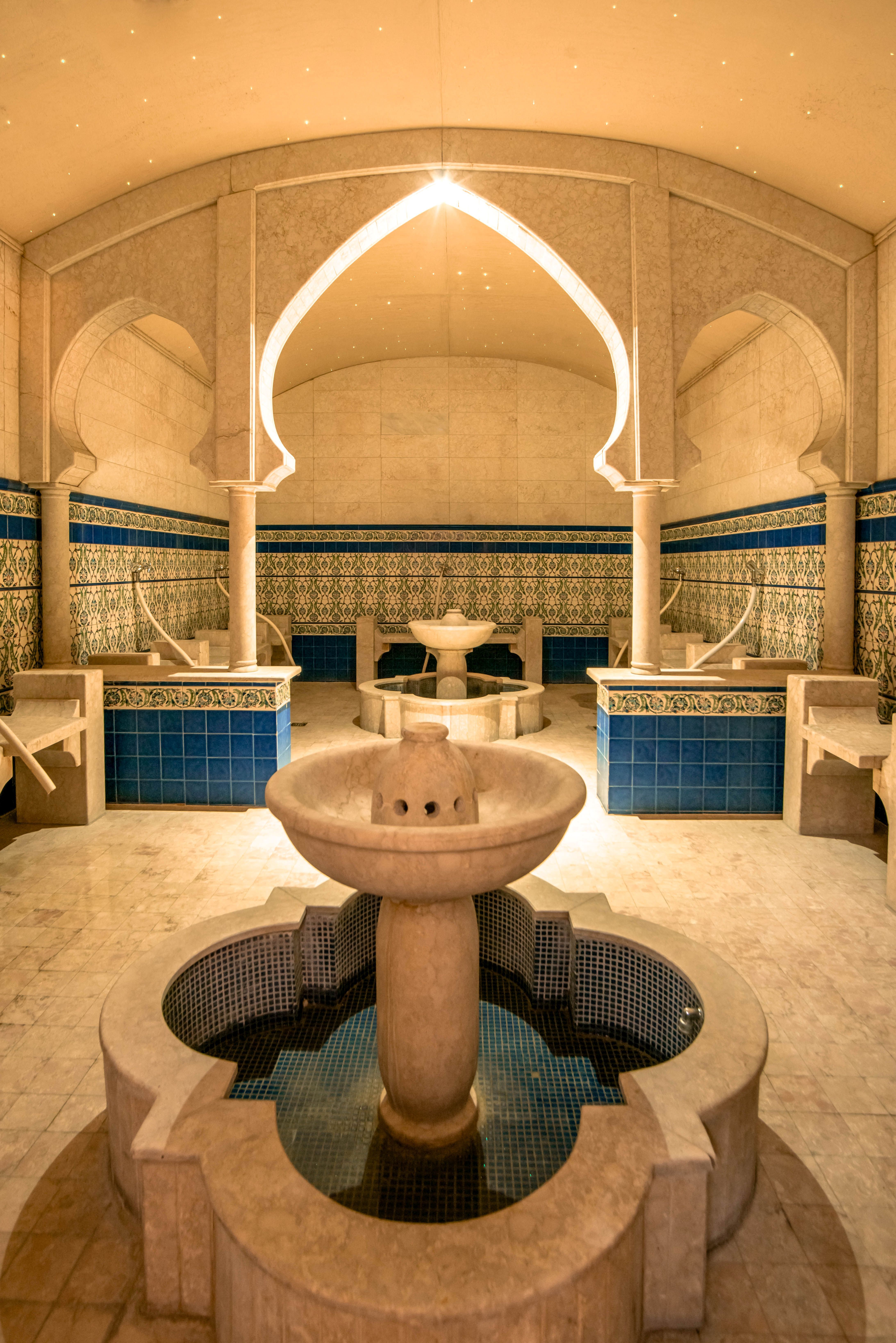 Magnificent, oriental-style hammam with a central fountain and ornate tile patterns
