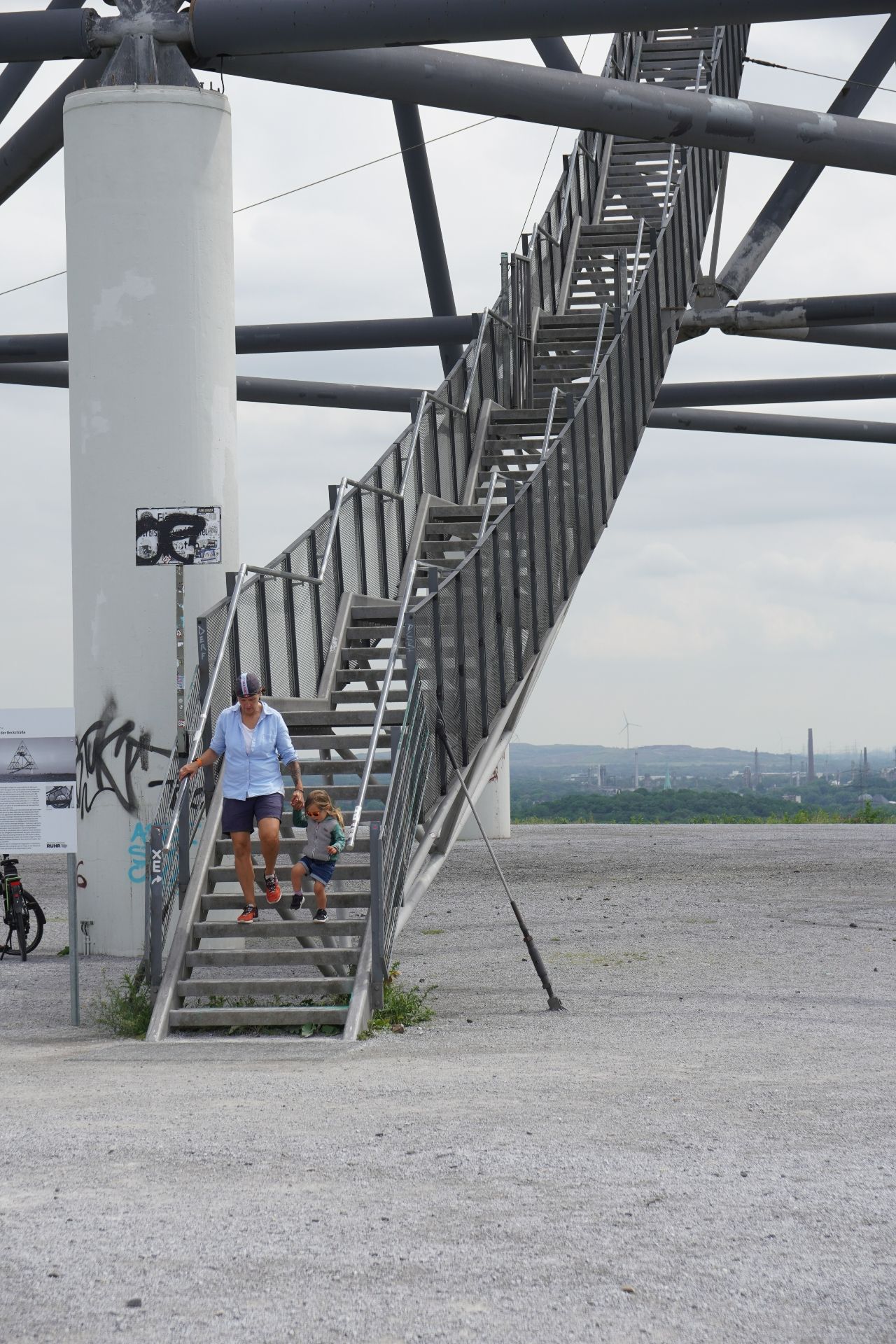 A woman and a child descend the stairs of the Tetraeder at the Halde Beckstraße in Bottrop together