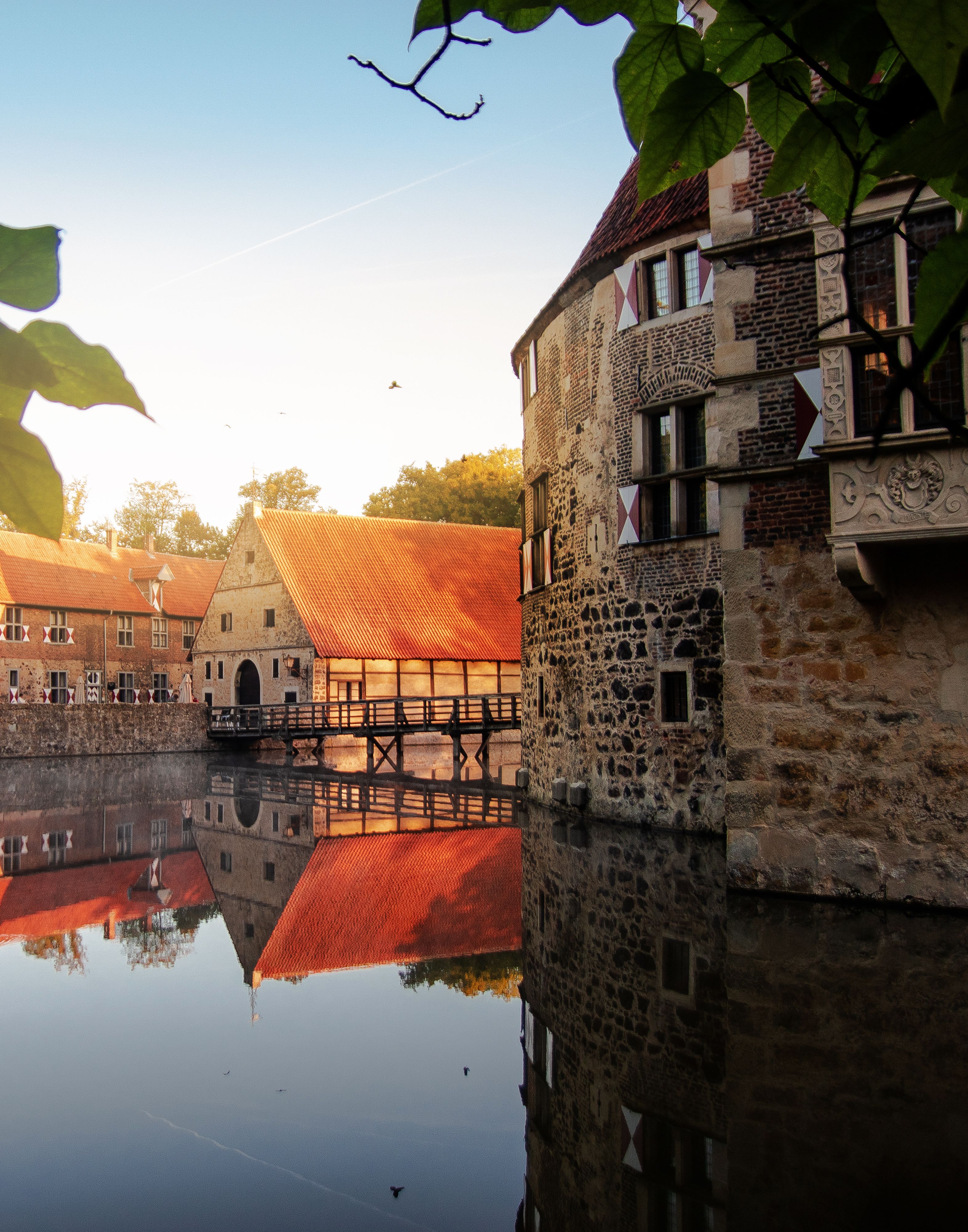 Vischering Castle is reflected picturesquely in the water.