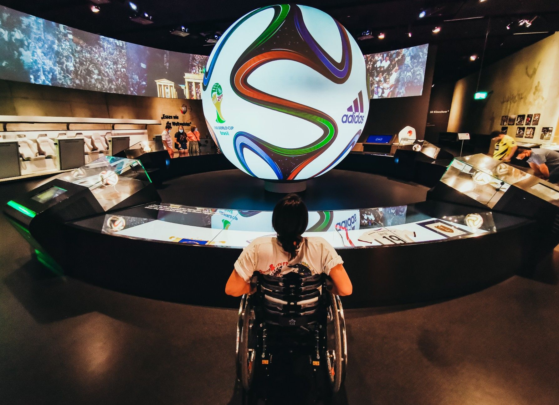 Blogger Kim Lumelius in front of the large illuminated soccer in the German Football Museum in Dortmund, Ruhr Area